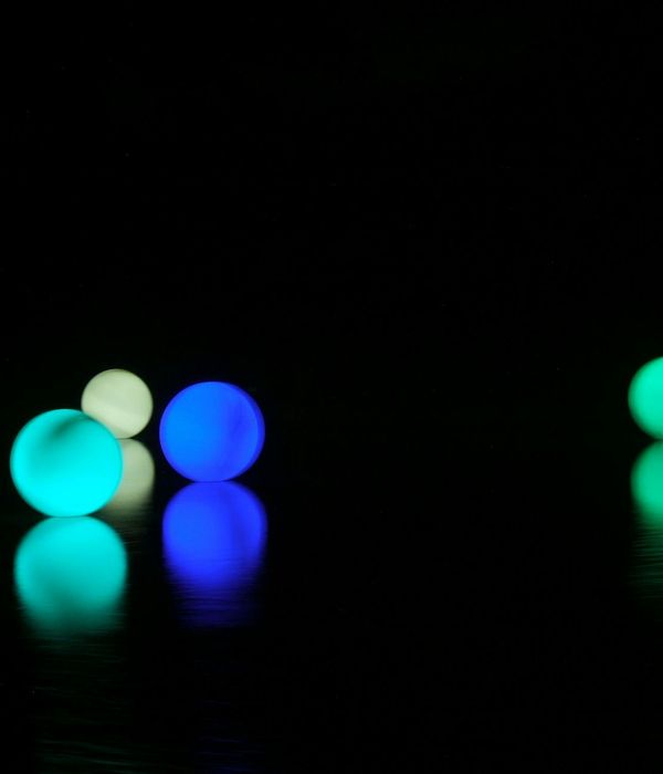 Abstract blue and violet glowing spheres representing energy balance